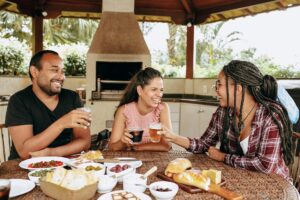 Friends eating artesian food on a patio in a tropical location
